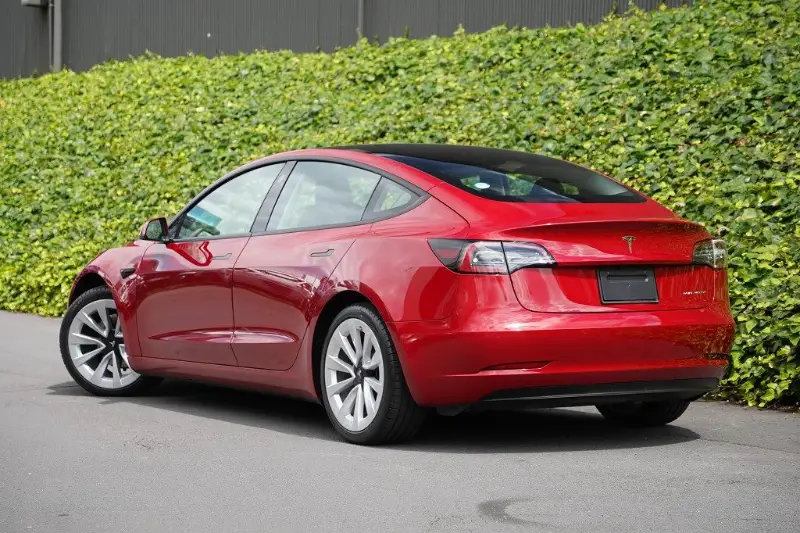 Red Tesla Model 3 parked at the GVI workshop