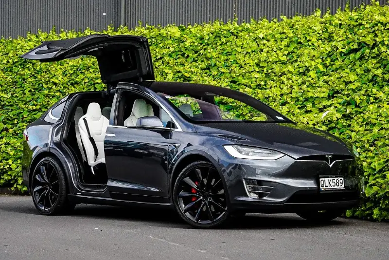 Grey Tesla Model X with falcon wing doors raised